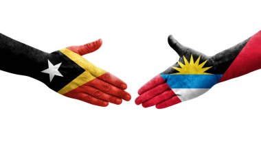 Antigua ve Barbuda ile Timor Leste bayrakları arasındaki el sıkışma, izole şeffaf görüntü.