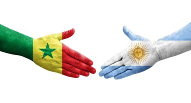 Ellerinde Arjantin ve Senegal bayrakları arasında el sıkışma, izole şeffaf görüntü.