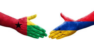 Ellerinde Ermenistan ve Gine Bissau bayrakları arasında el sıkışma, izole şeffaf görüntü.