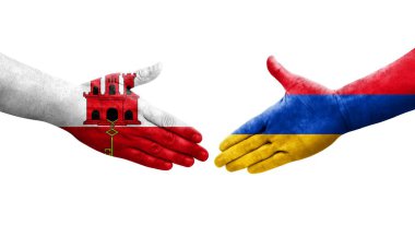 Ellerinde Ermenistan ve Cebelitarık bayrakları arasında el sıkışma, izole şeffaf görüntü.