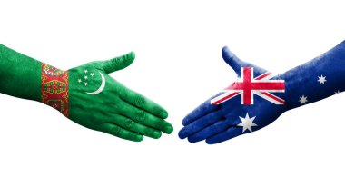Ellere boyanmış Avustralya ve Türkmenistan bayrakları arasındaki el sıkışma, izole edilmiş şeffaf görüntü.