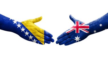 Ellere boyanmış Avustralya ve Bosna bayrakları arasındaki el sıkışma, izole şeffaf görüntü.