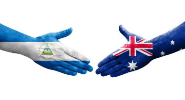Avustralya ve Nikaragua bayrakları arasındaki el sıkışma ellerinde resmedilmiş, şeffaf görüntü.