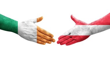 Ellerinde Avusturya ve İrlanda bayrakları arasında el sıkışma, izole şeffaf görüntü.