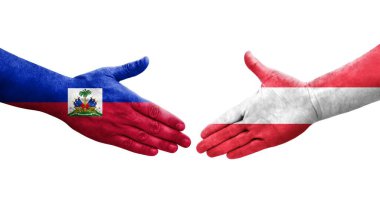 Avusturya ve Haiti bayrakları arasındaki el sıkışma, izole şeffaf görüntü.