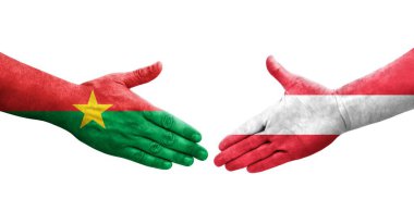 Avusturya ve Burkina Faso bayrakları arasındaki el sıkışma ellerinde izole şeffaf görüntü.