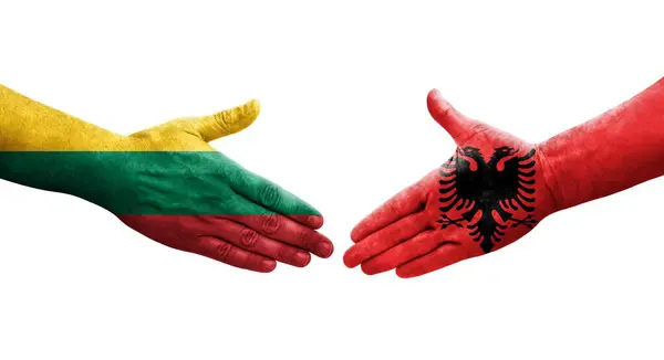 stock image Handshake between Albania and Lithuania flags painted on hands, isolated transparent image.