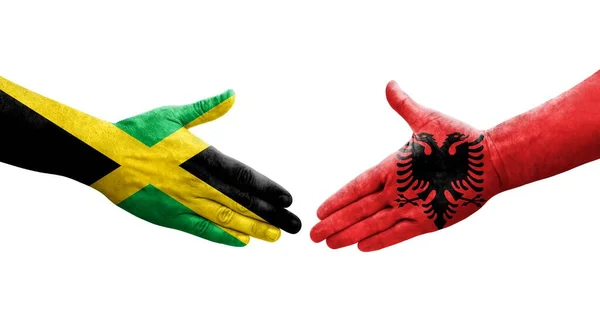 Håndtrykk Mellom Albania Jamaica Flagg Malt Hender – stockfoto