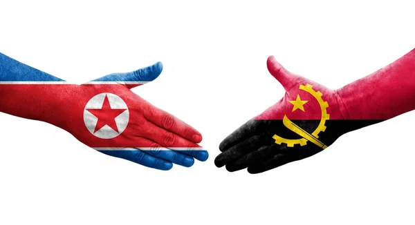 Uścisk Dłoni Między Angolą Koreą Północną Flagi Malowane Rękach Odizolowany — Zdjęcie stockowe