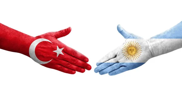 手に描かれたアルゼンチンとトルコの旗の間の握手 孤立した透明なイメージ — ストック写真