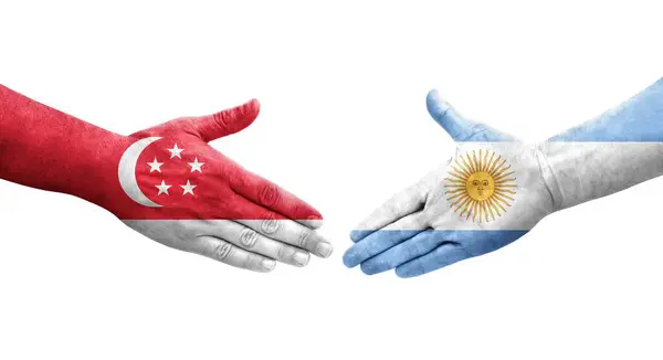 stock image Handshake between Argentina and Singapore flags painted on hands, isolated transparent image.