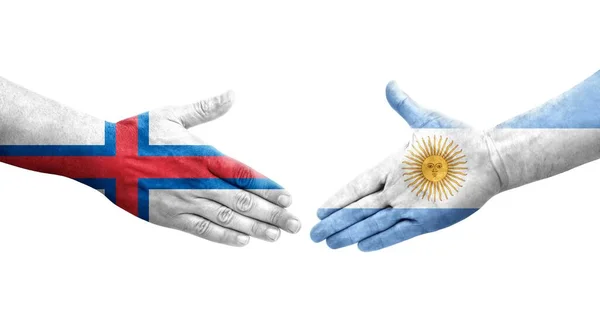 stock image Handshake between Argentina and Faroe Islands flags painted on hands, isolated transparent image.