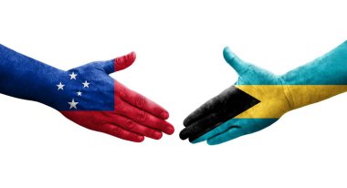 Bahamalar ve Samoa bayrakları arasındaki el sıkışma ellerinde izole şeffaf görüntü.