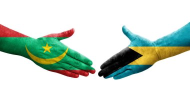 Bahamalar ve Moritanya bayrakları arasındaki el sıkışma ellerinde izole şeffaf görüntü.