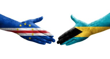 Bahamalar ve Cape Verde bayrakları arasındaki tokalaşma elleri boyalı, izole şeffaf görüntü.