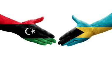 Bahamalar ve Libya bayrakları arasındaki el sıkışma, izole edilmiş şeffaf görüntü.