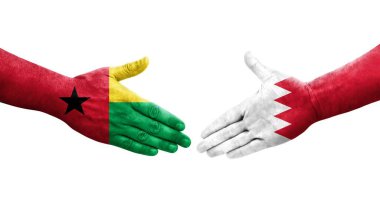 Bahreyn ve Gine Bissau bayrakları arasındaki tokalaşma elleri boyalı, izole şeffaf görüntü.