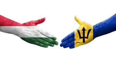 Ellerinde Barbados ve Macaristan bayrakları arasında el sıkışma, izole şeffaf görüntü.