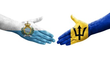 Ellerinde Barbados ve San Marino bayrakları arasında el sıkışma, izole saydam görüntü.
