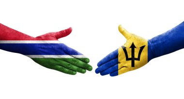 Ellerinde Barbados ve Gambiya bayrakları arasında el sıkışma, izole şeffaf görüntü.
