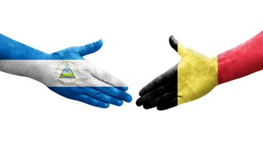 Belçika ve Nikaragua bayrakları arasında el sıkışma, izole şeffaf görüntü.