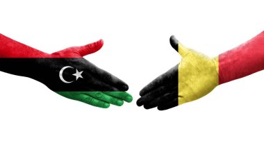 Belçika ve Libya bayrakları arasındaki el sıkışma, izole şeffaf görüntü.