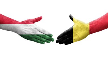 Ellerinde Belçika ve Macaristan bayrakları arasında el sıkışma, izole şeffaf görüntü.