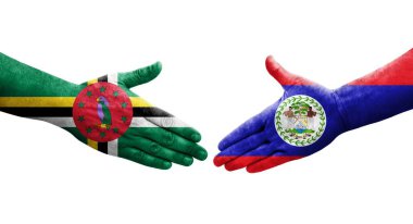 Belize ve Dominica bayrakları arasındaki el sıkışma ellerinde resmedilmiş şeffaf görüntü.