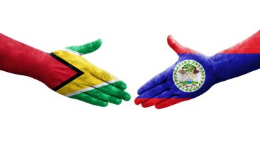 Belize ve Guyana bayrakları arasındaki el sıkışma ellerinde resmedilmiş şeffaf görüntü.