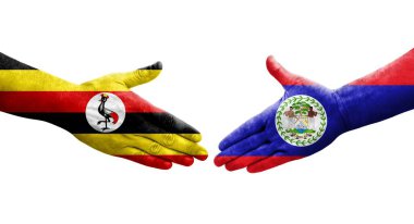 Belize ve Uganda bayrakları arasındaki tokalaşma elleri boyalı, izole şeffaf görüntü.