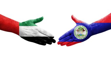 Belize ve BAE bayrakları arasındaki tokalaşma elleri boyalı, izole şeffaf görüntü.