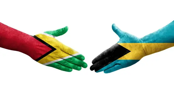 Aperto Mão Entre Bahamas Bandeiras Guiana Pintadas Mãos Imagem Transparente — Fotografia de Stock