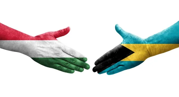 stock image Handshake between Bahamas and Hungary flags painted on hands, isolated transparent image.