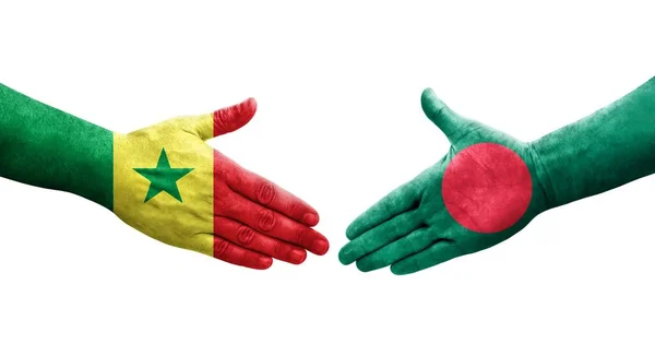 stock image Handshake between Bangladesh and Senegal flags painted on hands, isolated transparent image.