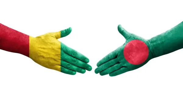 stock image Handshake between Bangladesh and Guinea flags painted on hands, isolated transparent image.