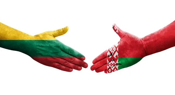 stock image Handshake between Belarus and Lithuania flags painted on hands, isolated transparent image.