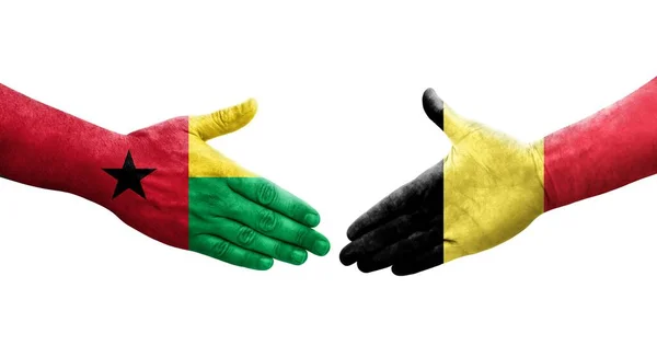 stock image Handshake between Belgium and Guinea Bissau flags painted on hands, isolated transparent image.