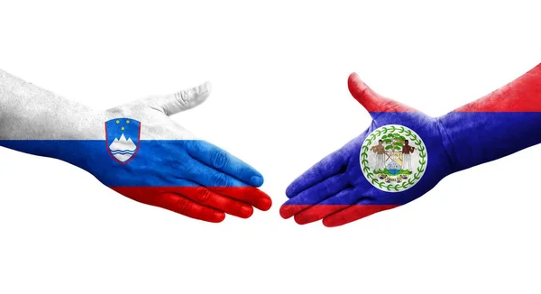 stock image Handshake between Belize and Slovenia flags painted on hands, isolated transparent image.