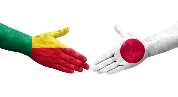 stock image Handshake between Benin and Japan flags painted on hands, isolated transparent image.