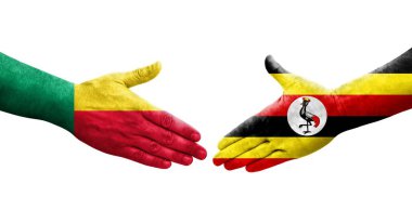 Benin ve Uganda bayrakları arasındaki el sıkışma ellerinde resmedilmiş şeffaf görüntü.