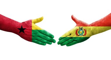 Bolivya ve Gine Bissau bayrakları arasındaki el sıkışma ellerinde resmedilmiş şeffaf görüntü.