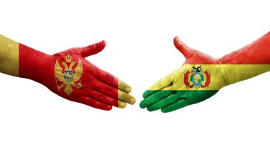 Bolivya ile Karadağ arasındaki el sıkışma ellerinde boyanmış bayraklar, izole edilmiş şeffaf görüntü.