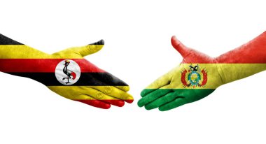 Ellere bolivya ve Uganda bayrakları arasında el sıkışma, izole şeffaf görüntü.
