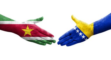 Bosna ve Surinam bayrakları arasındaki el sıkışma, izole edilmiş şeffaf görüntü.