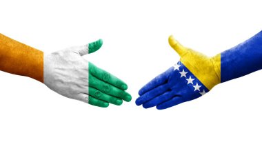Bosna ve Fildişi Sahili bayrakları arasındaki el sıkışma, izole edilmiş şeffaf görüntü.