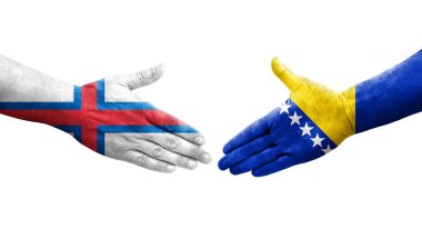 Bosna ve Faroe Adaları arasındaki el sıkışma ellerinde boyanmış bayraklar, izole edilmiş şeffaf görüntü.