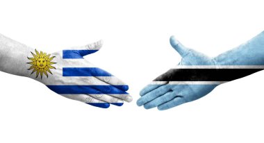 Botswana ve Uruguay bayrakları arasındaki el sıkışma ellerinde izole şeffaf görüntü.