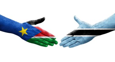 Botswana ve Güney Sudan bayrakları arasındaki el sıkışma ellerinde resmedilmiş şeffaf görüntü.