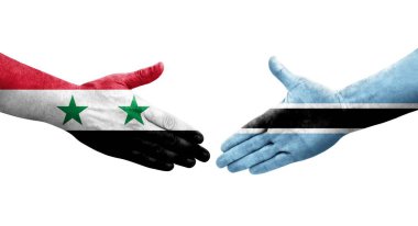 Ellerinde Botsvana ve Suriye bayrakları arasında el sıkışma, izole saydam görüntü.