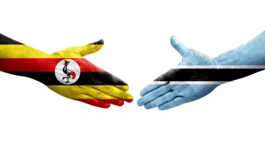 Ellerinde Botswana ve Uganda bayrakları arasında el sıkışma, izole şeffaf görüntü.